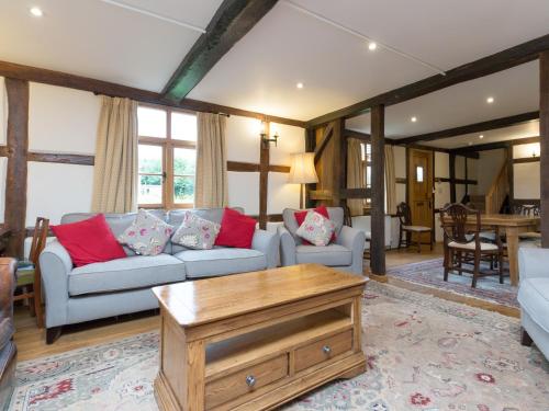 a living room with two couches and a coffee table at Brook House in Mathon