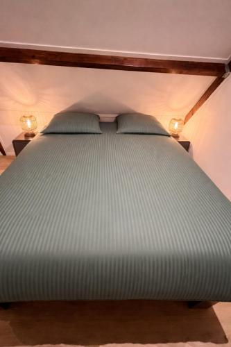 a bed with two pillows on it in a room at B&B Mirre in Kapelle