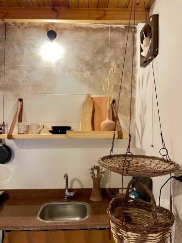 a kitchen with a sink and a basket on a counter at Timber House Dahab in Dahab