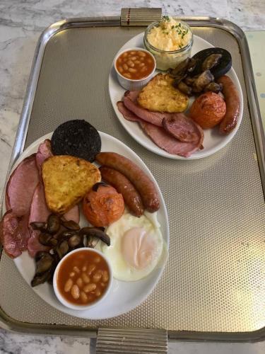 two plates of breakfast food on a tray at Hornby Villa B&B Couples & Families Only- Quiet Central Location- Near To Winter Gardens in Blackpool