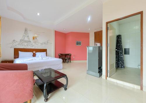 a hotel room with a bed and a glass table at Sun and beach hotel in Pattaya South