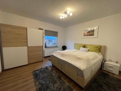 a bedroom with a large bed and a window at Close to Goettingen - unweit von Göttingen in Nörten-Hardenberg