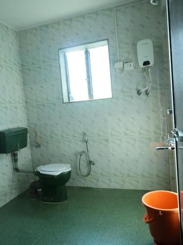 拉特纳吉里Hotel sabera residency的带马桶和窗户的浴室