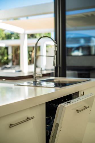 a kitchen counter with a sink and a sink at Casa Paloma with heated pool in El Roque in El Cotillo