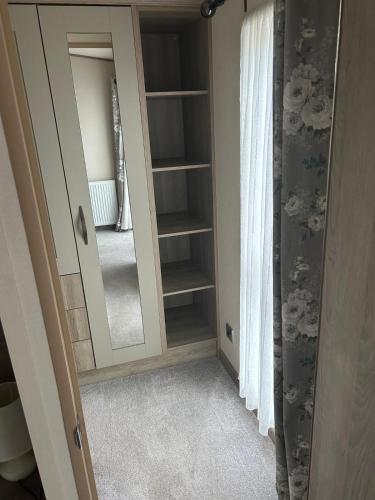 a dressing room with a mirror and a closet at Bude 20 in Newquay