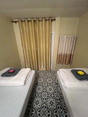 a room with two beds with towels on them at KiKi HOSTEL in Haad Rin