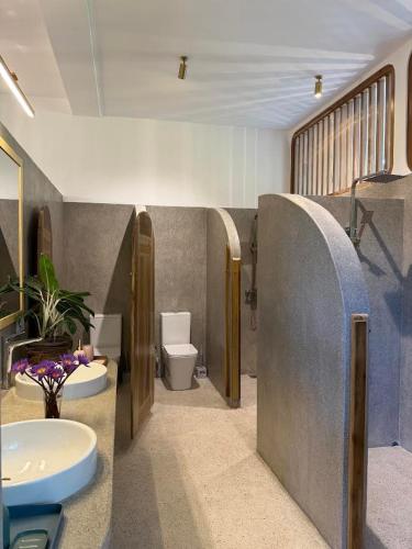 a bathroom with a sink and a toilet at JJ JungleJoy Villa in Unawatuna
