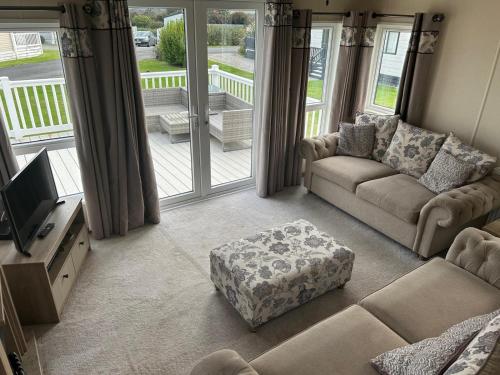 a living room with a couch and a tv at Bude 20 in Newquay