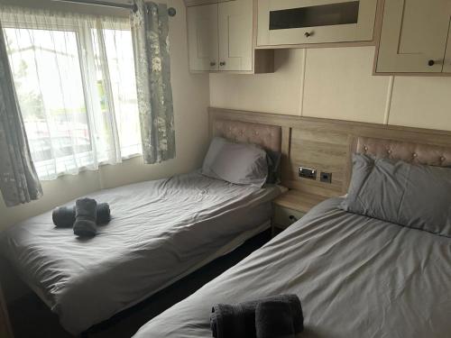 a bedroom with two beds and a window at Bude 20 in Newquay