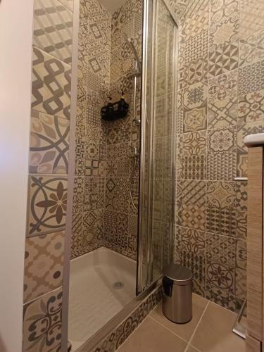 a shower with a glass door in a bathroom at Le studio des quais in Bergerac