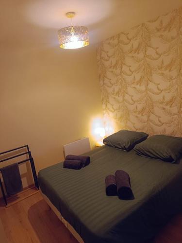 a bedroom with a bed with two towels on it at Le studio des quais in Bergerac