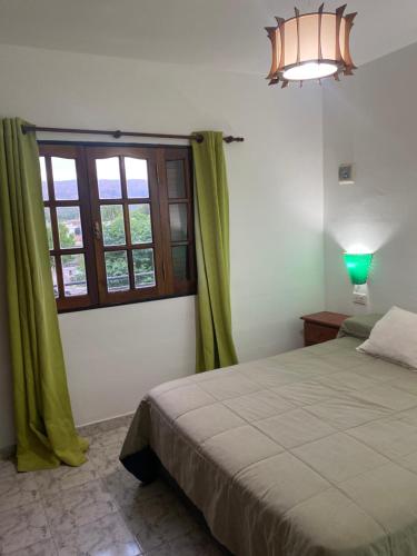 En eller flere senge i et værelse på Abdulle Complejo Turistico Centro