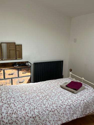 a bedroom with a bed and a mirror on the wall at Gite St Vincent in Foix