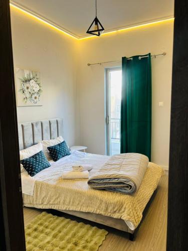 a bedroom with a bed with a green shower curtain at Μateo suite in Levádeia