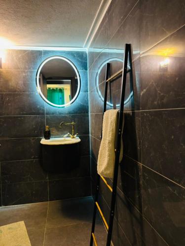 a bathroom with a sink and a mirror at Μateo suite in Levádeia