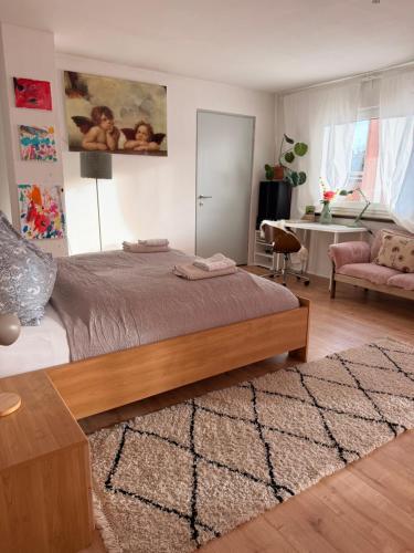 a bedroom with a bed and a living room at Waldblick Gästezimmer in Sonnenbühl