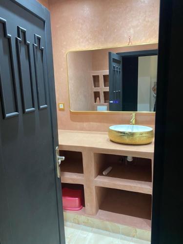 a bathroom with a sink and a mirror at Chez balqis atlas golf in Marrakesh
