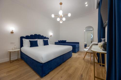 a blue and white bedroom with a bed and a table at SM Vatican Relais B&B in Rome
