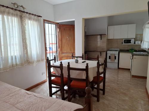 a kitchen with a table and chairs in a room at Departamentos MDA MIC in Mar de Ajó