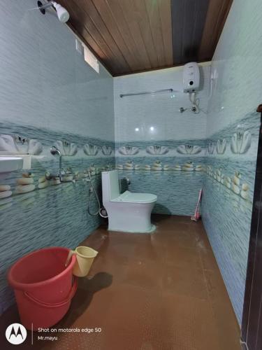 a bathroom with a toilet and a sink at Gokarna Govekar Sea Facing Rooms in Gokarn