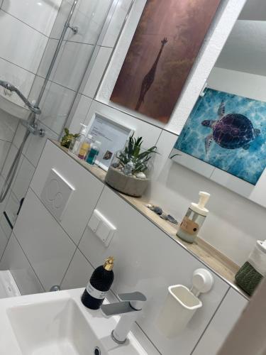 a white bathroom with a sink and a toilet at Appartement am Teich 2 in Krefeld
