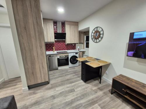 a large kitchen with a table in the middle at Escola in Ourense