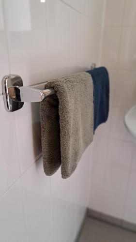 a towel rack with two towels on it in a bathroom at Beutenaken Drie in Beutenaken