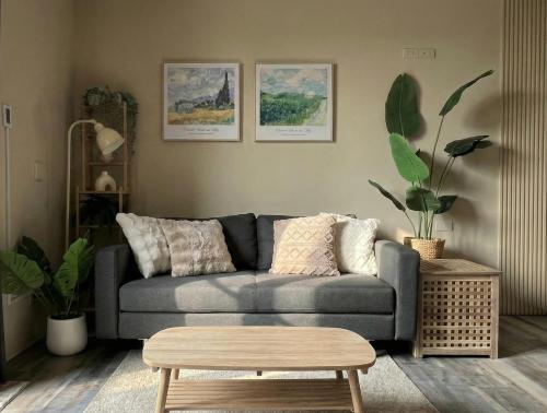 a living room with a couch and a coffee table at Forgotten Boundless Offland in Wujie