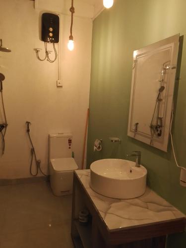 a bathroom with a sink and a toilet at SiSi Place in Dickwella