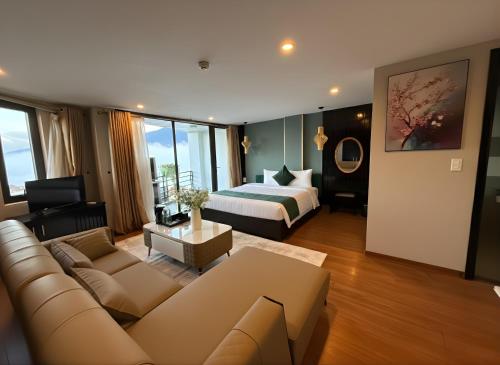a living room with a couch and a bed in a room at Beautiful Sapa Hotel in Sa Pa