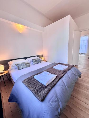 a bedroom with two beds with towels on them at Schuman Square Residence in Brussels