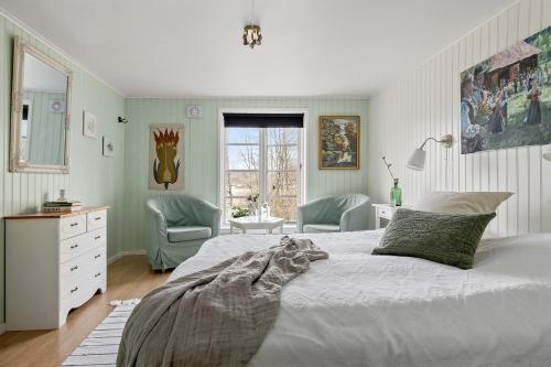 una camera da letto con un letto grande e due sedie di Älvbacken a Västerlanda