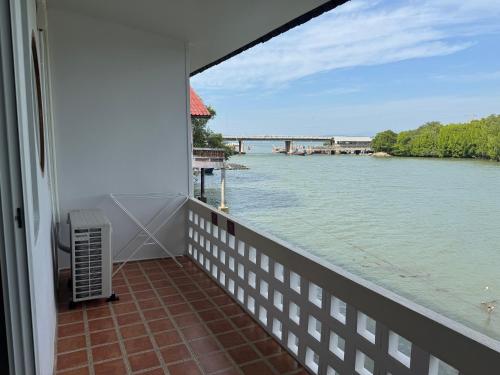 a balcony with a view of the water at Madee House - มาดีเฮ้าส์ in Ban Ao Yang