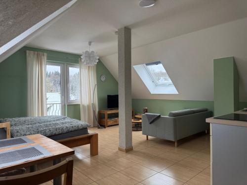 a bedroom with a bed and a couch and a table at Magdalena Apartment 2 in Elend