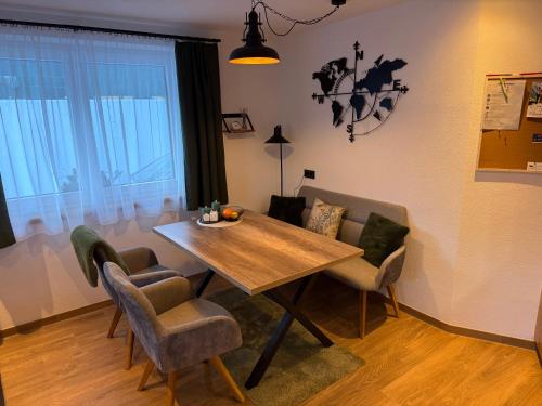 a dining room with a wooden table and chairs at Appartement Bergsicht in Leogang