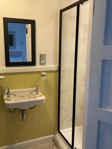a bathroom with a sink and a shower at 7 Goathill Crescent in Stornoway