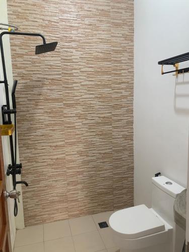a bathroom with a toilet and a shower at Mountain View Anilao in Mabini