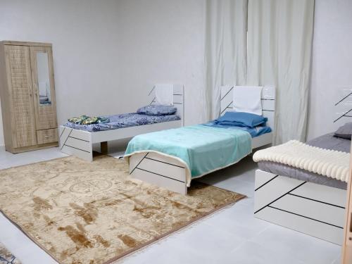 a room with two beds and a mirror at Alharamil Retreat in Ras al Khaimah