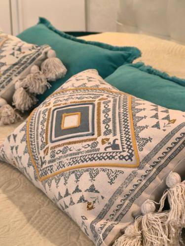 a bed with two pillows on top of it at Villa Rosa in Chia