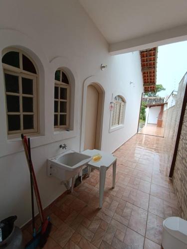 a bathroom with a sink and a toilet at Casa Duque Peruíbe in Peruíbe