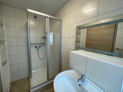 a bathroom with a shower and a toilet with a mirror at City Lux Hannover in Hannover