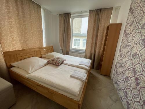 a small bedroom with a bed and a window at City Lux Hannover in Hannover