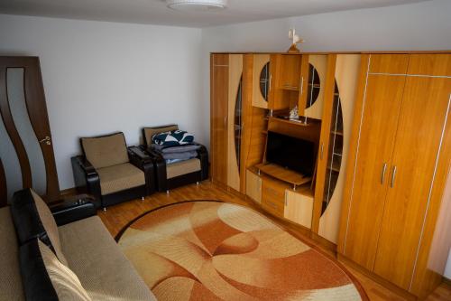a small living room with a couch and a chair at House Dey in Făgăraş