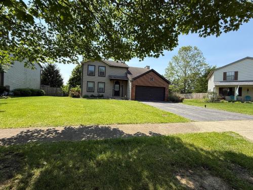 a house with a driveway and a grass yard at Private Cul-de-Sac Oasis 4BR in Grove City