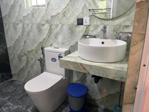 a bathroom with a sink and a toilet at Lio Villa in Habaraduwa Central