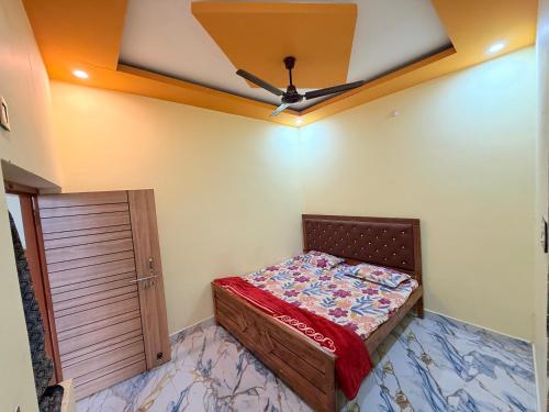 a bedroom with a bed and a ceiling at Hotel embrace in Bhauli