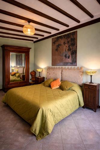 a large bed in a bedroom with two lamps at Vita Toscana in Chiusi