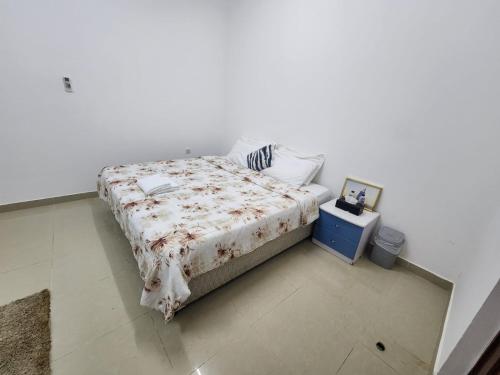 a bedroom with a bed with a comforter on it at Room with Shared bath only in Al Ain
