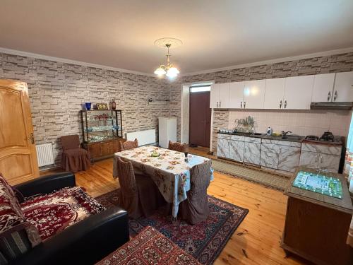 a living room with a table and a kitchen at Heaven apartment in Gabala