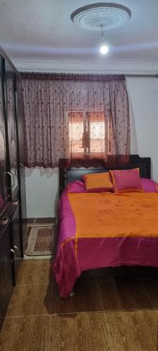 a bedroom with a bed and a window at Horizon heights in El Haouma